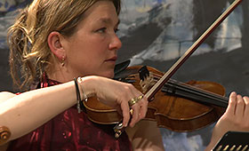 A closeup of a violinist performing.