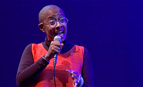 Singer Cecile McLorin Salvant sings into a microphone.