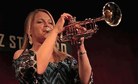 Jazz musician Bria Skonberg holds her trumpet up to her mouth during a performance at New York City club Jazz Standard.