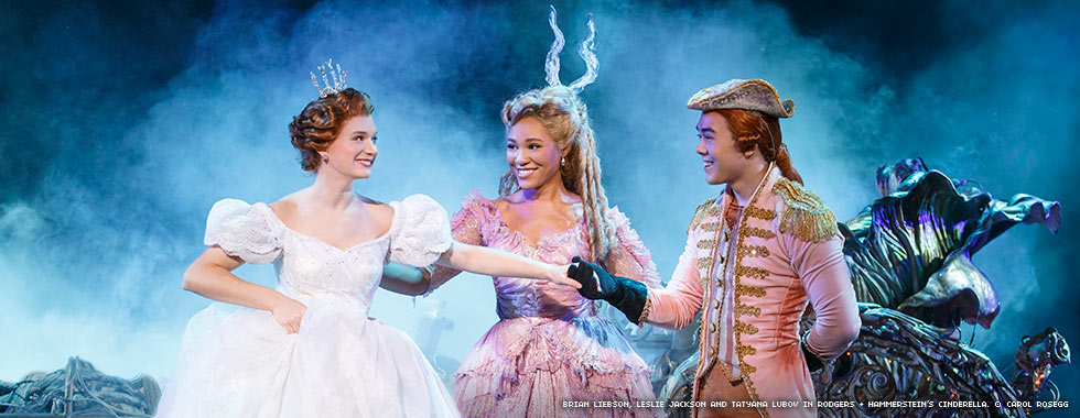 Cinderella smiles as her Fairy Godmother introduces her to her chariot driver.