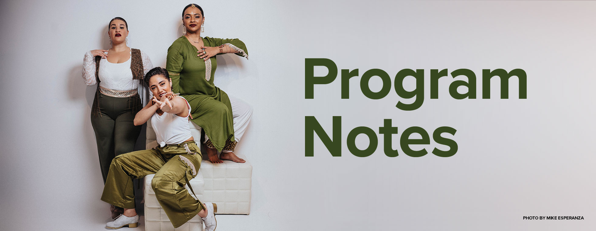 Four men stand together holding their violins, violas, and cellos.