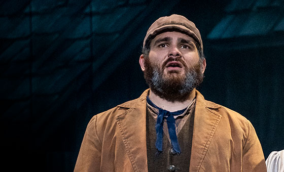 Jonathan Hashmonay sings on stage while dressed in costume as Tevye from Fiddler on the Roof.