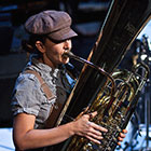 A musician from Darcy James Argue's Secret Society wears early twentieth-century period dress and plays a tuba in a performance of "Brooklyn Babylon."