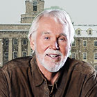 Rogers smiles in front of a snow covered Penn State Old Main building.