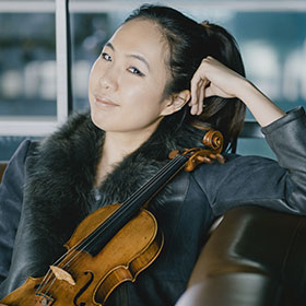 Danbi Um holds her violin.