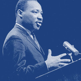 Martin Luther King Jr. speaks at a podium.