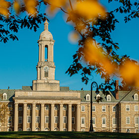 Old Main building with autumn leaves.