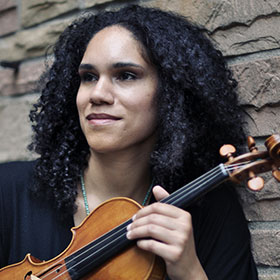 Jessie Montgomery holds her violin.
